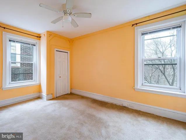an empty room with windows and closet