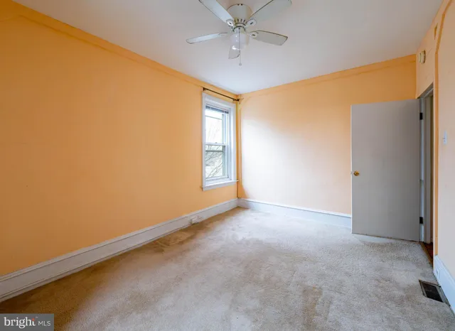 an empty room with windows and closet