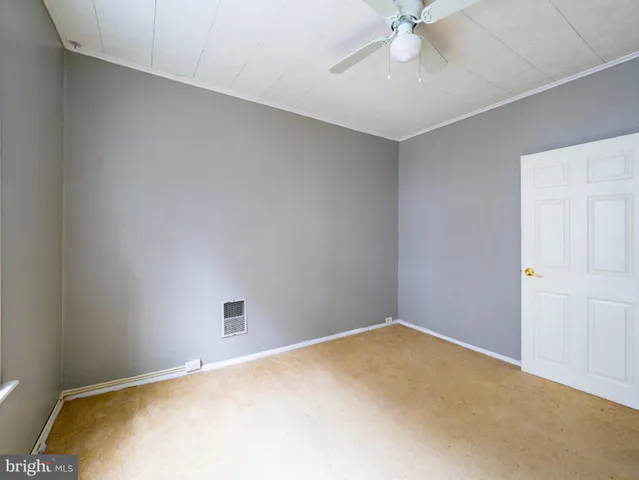a bedroom with a bed and a ceiling fan