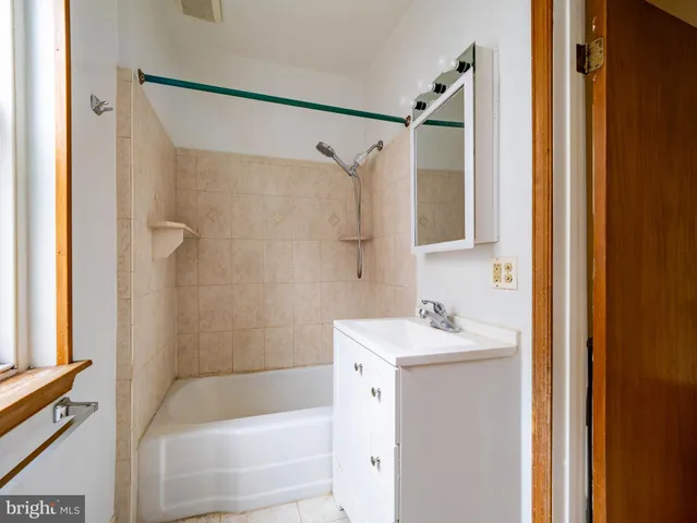 a bathroom with a sink mirror toilet and bathtub