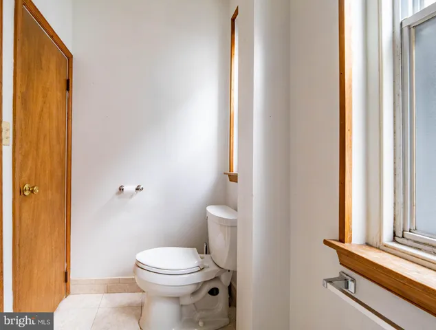 a bathroom with a toilet a sink and a window