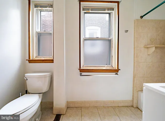a white toilet sitting next to a bathroom sink