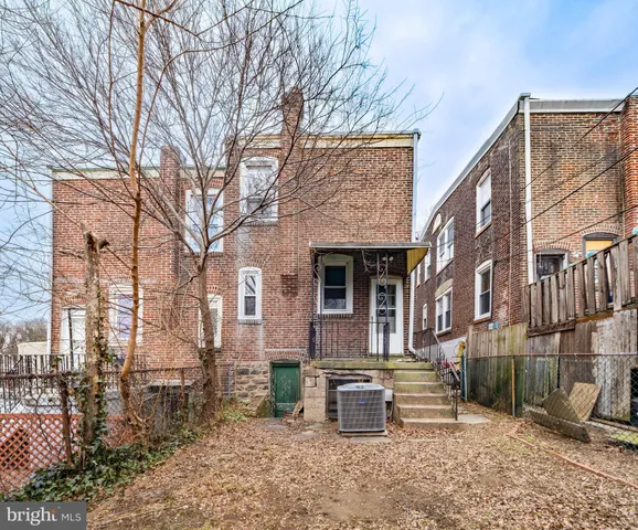 a view of a building with a yard and sitting area
