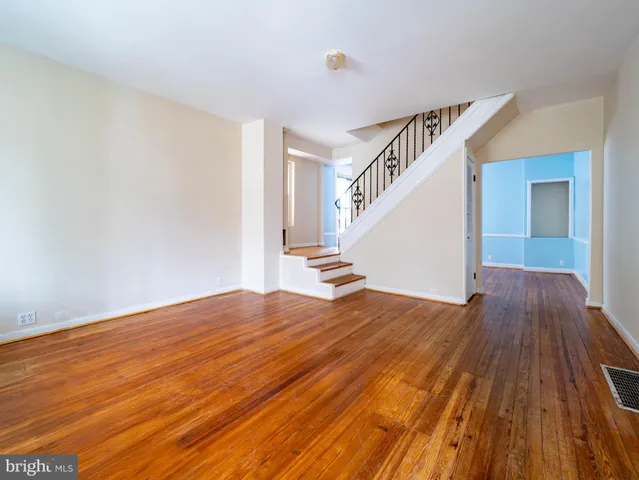 a view of a room with wooden floor and staircase