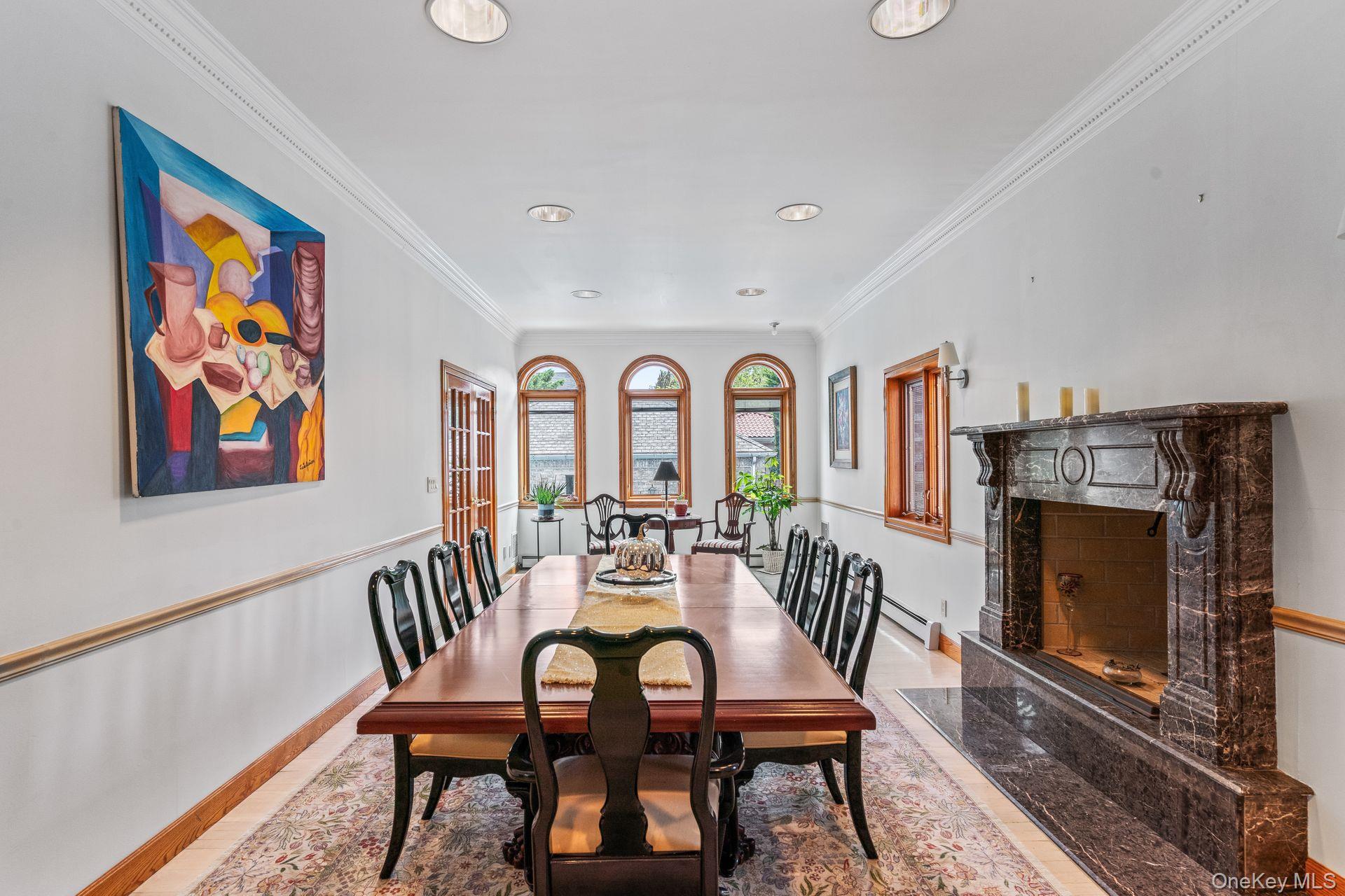 6 Summit Place Queens, NY 11357 - Photo 13 of 35 Dining area featuring crown molding, a high end fireplace, light wood finished floors, and recessed lighting