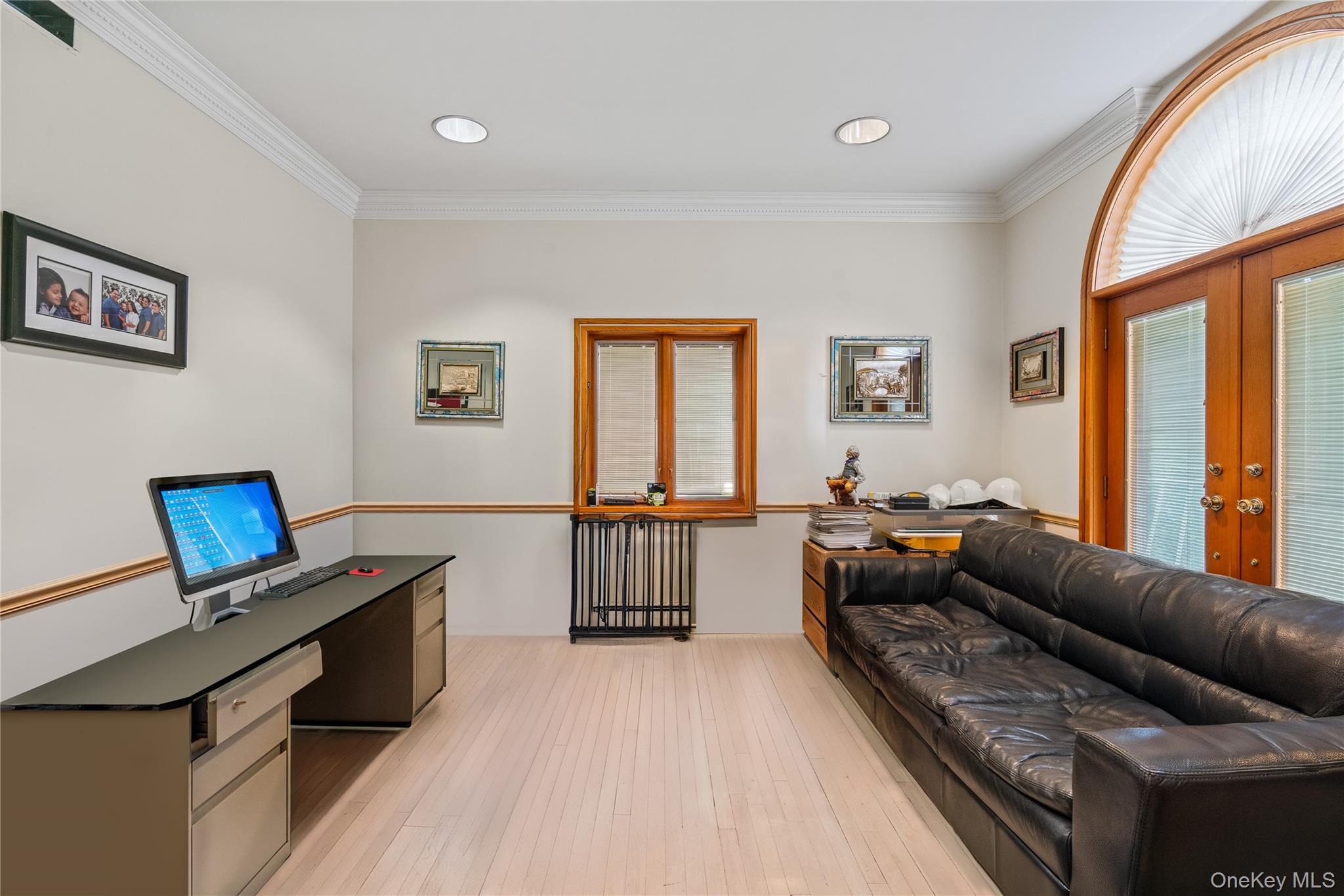 6 Summit Place Queens, NY 11357 - Photo 14 of 35 Living room with crown molding, light wood-type flooring, healthy amount of natural light, french doors, and radiator heating unit