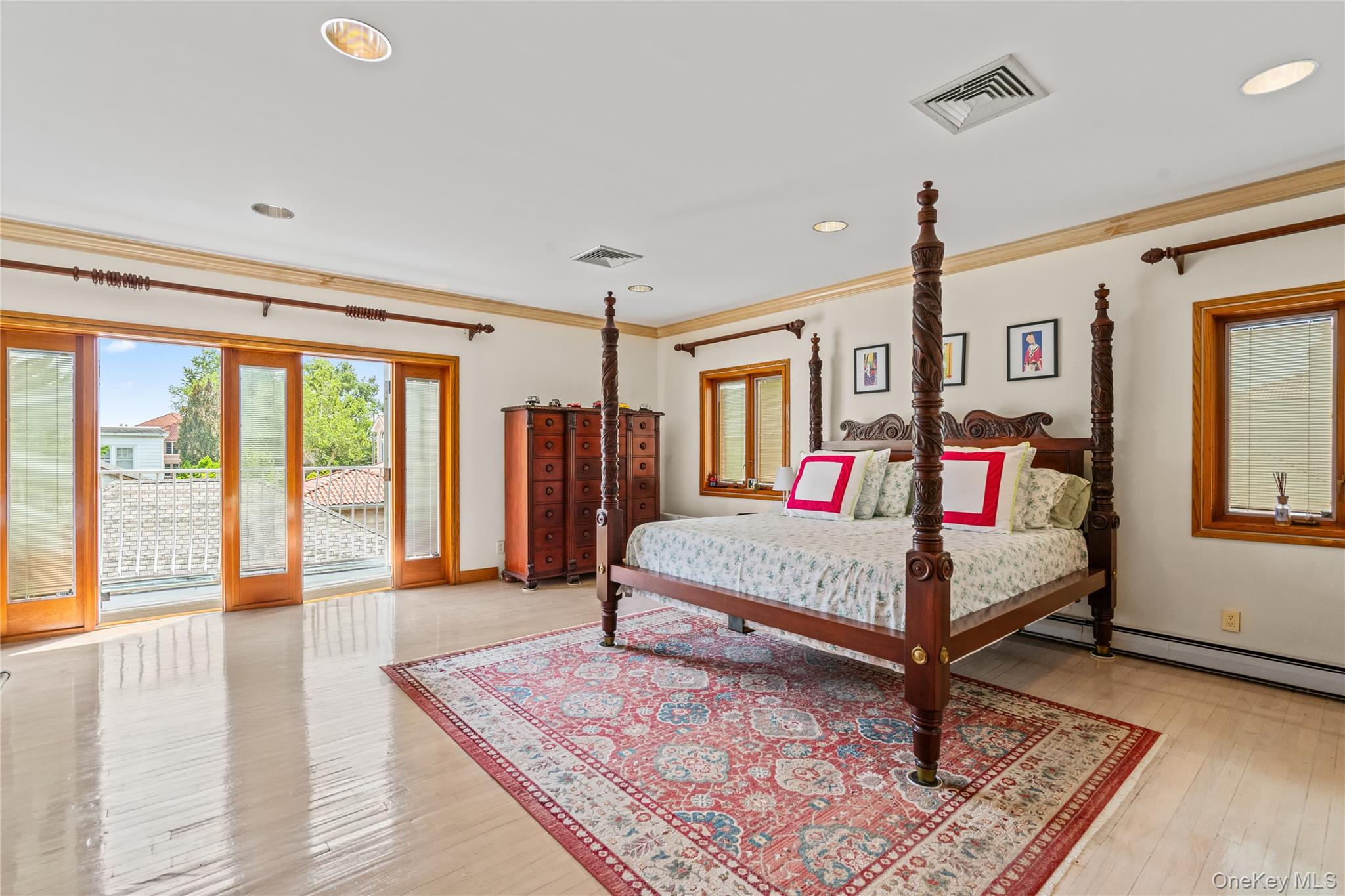6 Summit Place Queens, NY 11357 - Photo 15 of 35 Bedroom featuring multiple windows, ornamental molding, access to outside, light wood finished floors, and recessed lighting