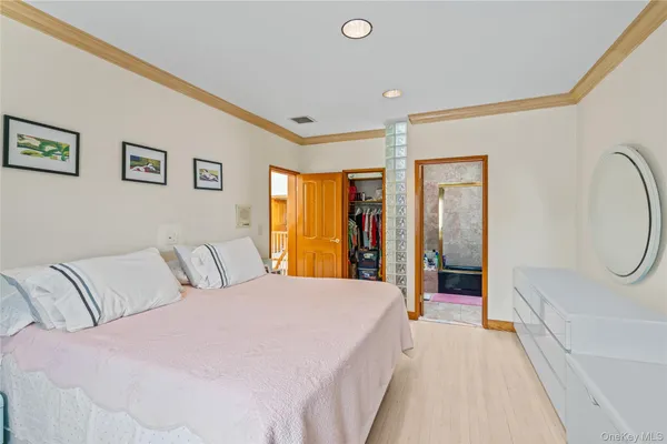 a bedroom with furniture and wooden floor