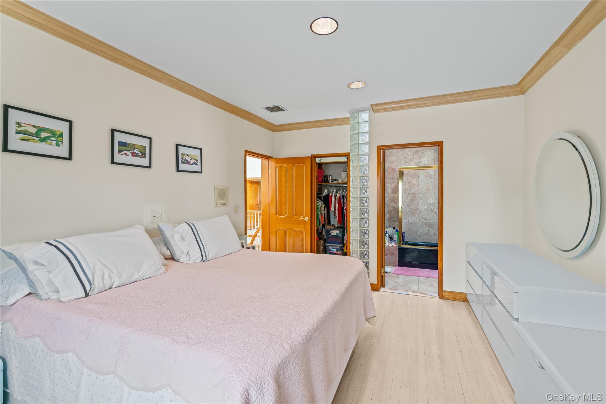 6 Summit Place Queens, NY 11357 - Photo 19 of 35 Bedroom with a walk in closet, crown molding, light wood-type flooring, recessed lighting, and ensuite bathroom