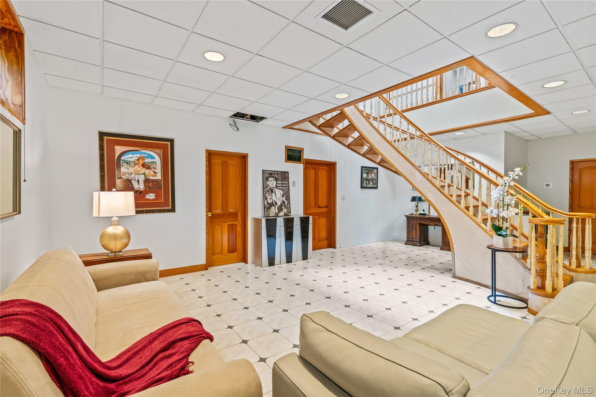 6 Summit Place Queens, NY 11357 - Photo 20 of 35 Living room with a drop ceiling and stairs
