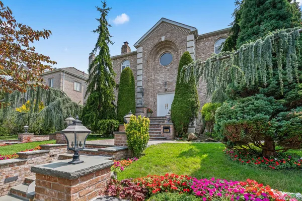 a view of a house with a garden and pathway