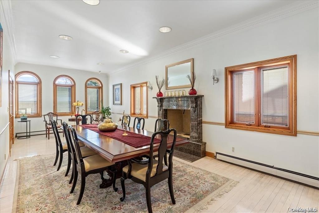 6 Summit Place Queens, NY 11357 - Photo 25 of 48 Dining space featuring light hardwood / wood-style flooring, ornamental molding, and baseboard heating