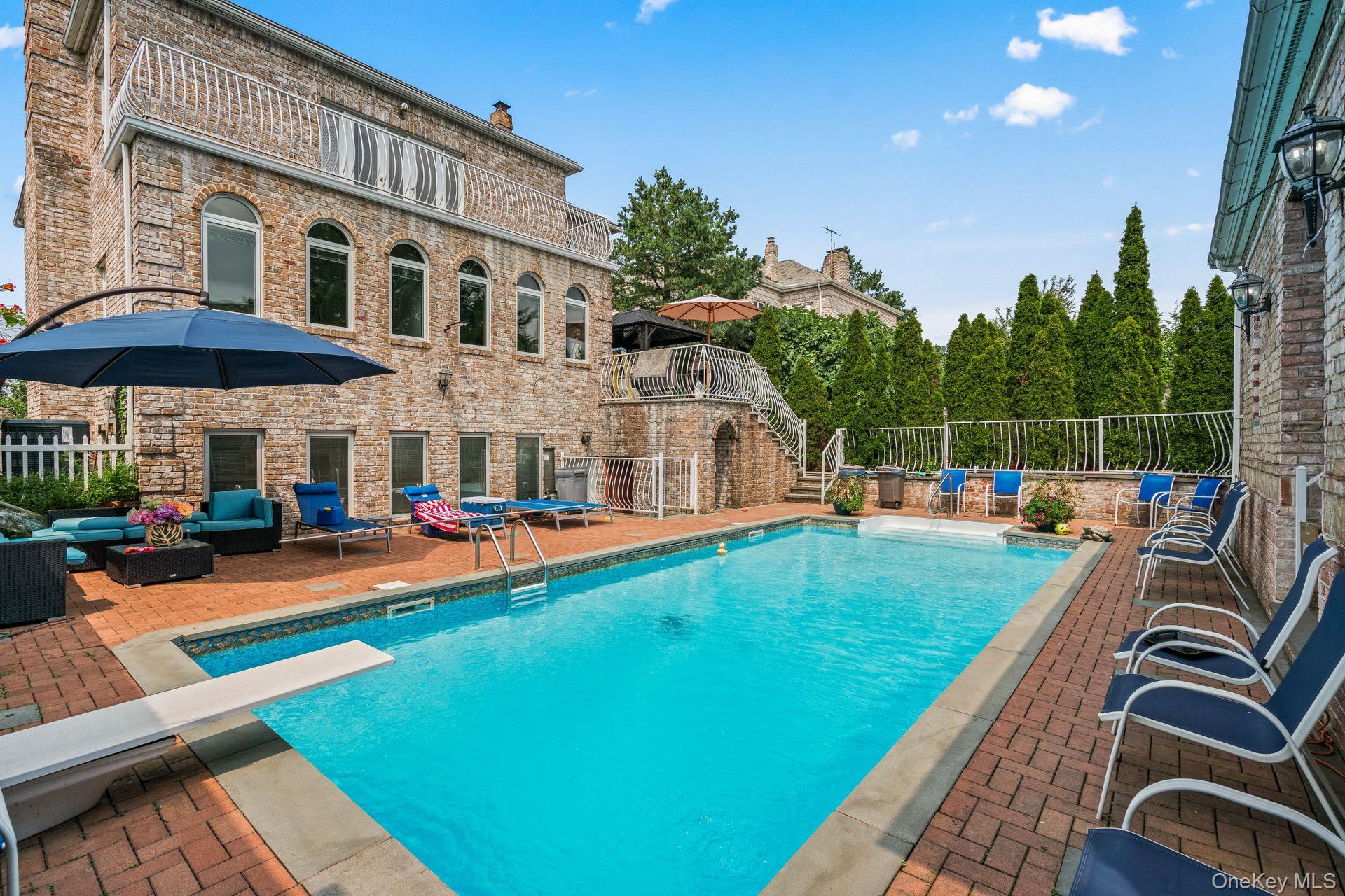 6 Summit Place Queens, NY 11357 - Photo 27 of 35 a view of a house with swimming pool and sitting area