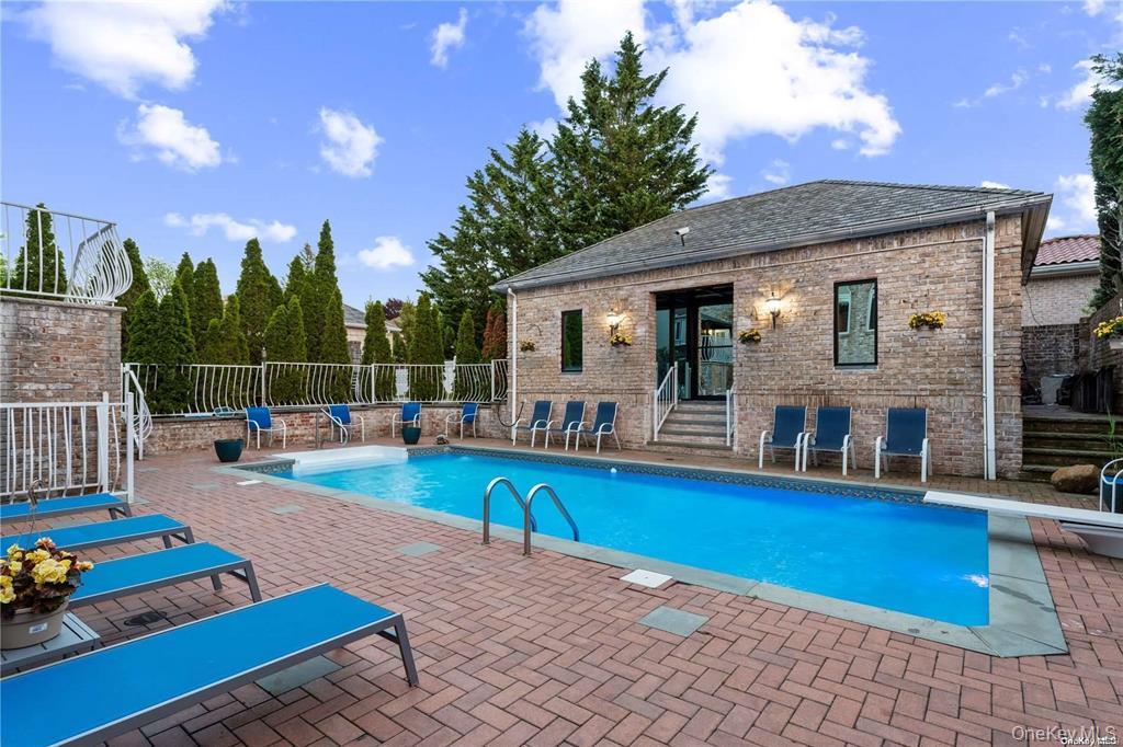 6 Summit Place Queens, NY 11357 - Photo 29 of 35 View of swimming pool with a diving board and a patio area