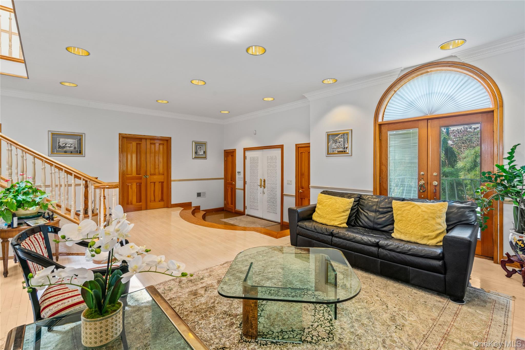 6 Summit Place Queens, NY 11357 - Photo 6 of 35 Living area featuring crown molding, light wood finished floors, recessed lighting, stairway, and french doors
