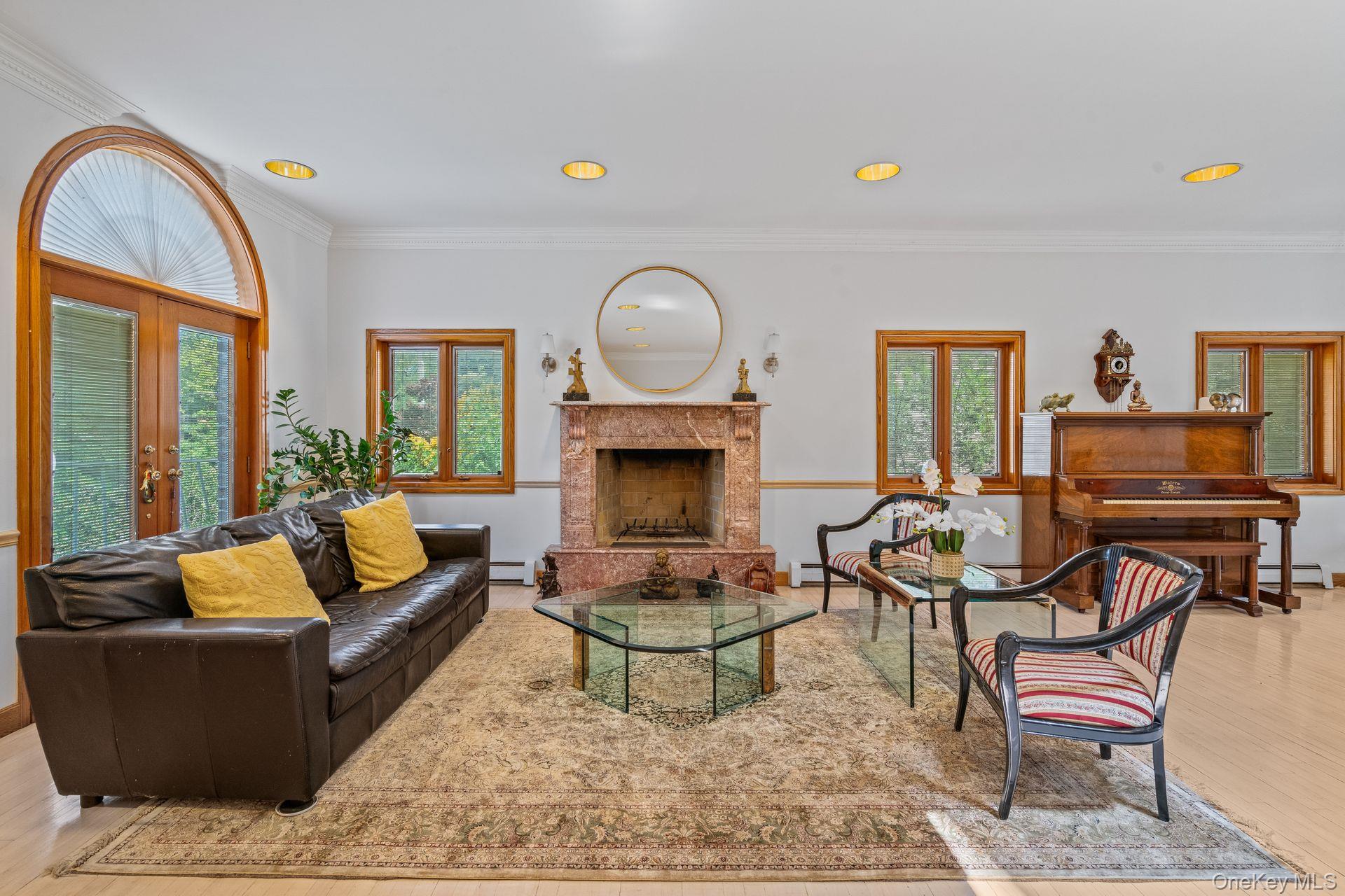 6 Summit Place Queens, NY 11357 - Photo 7 of 35 Living room with crown molding, light wood-style flooring, recessed lighting, a premium fireplace, and french doors