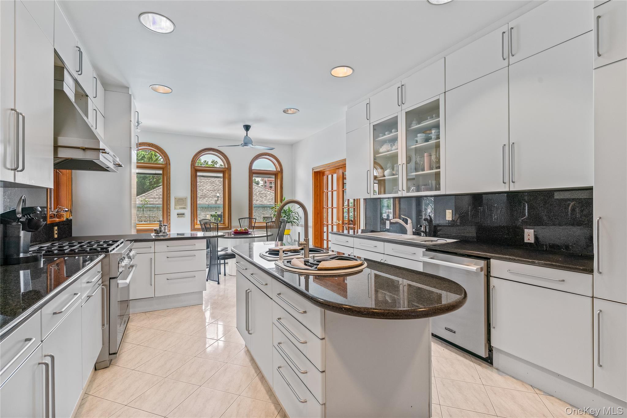 6 Summit Place Queens, NY 11357 - Photo 9 of 35 Kitchen featuring tasteful backsplash, glass insert cabinets, white cabinets, light tile patterned floors, and recessed lighting