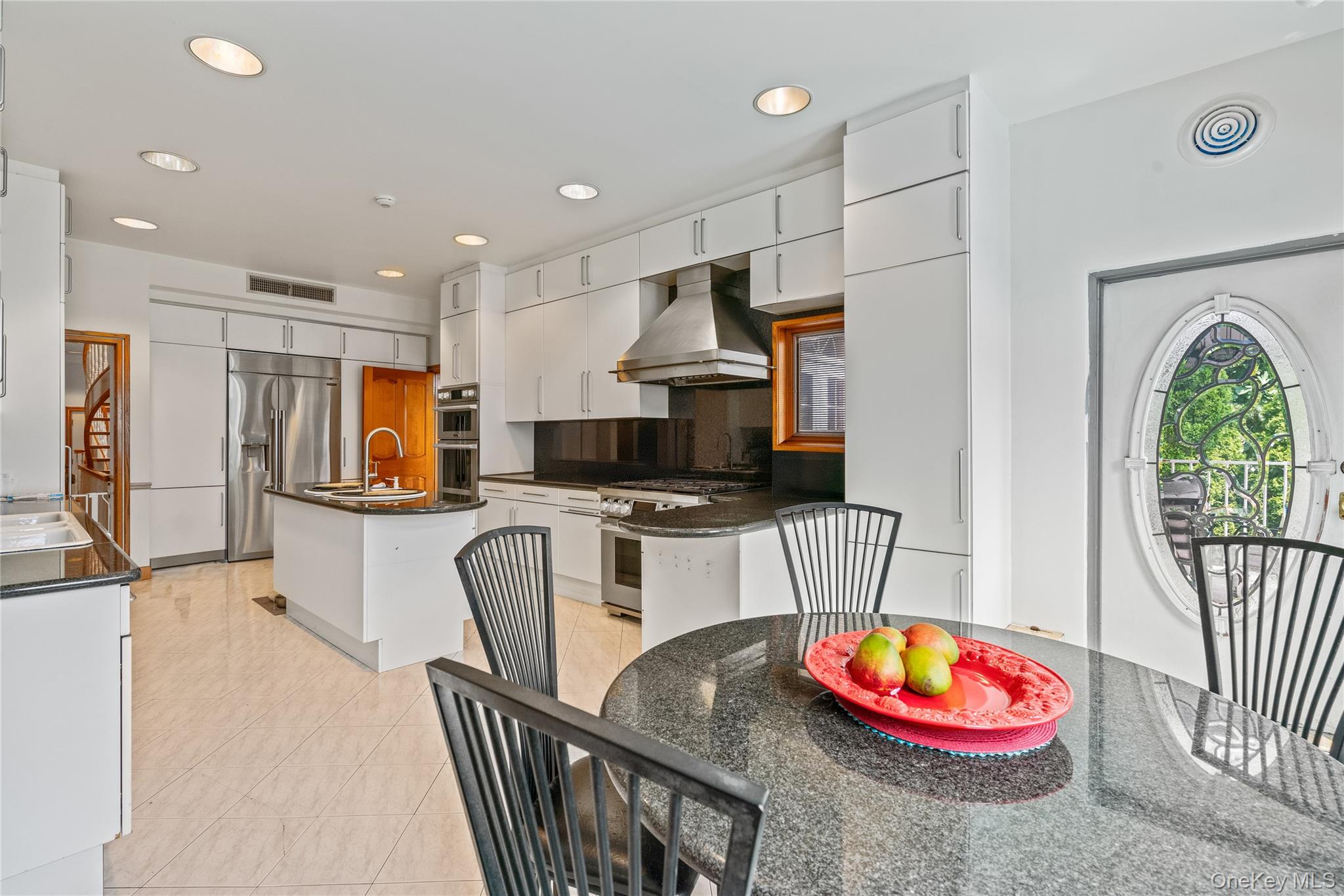 6 Summit Place Queens, NY 11357 - Photo 10 of 35 Kitchen with light tile patterned floors, recessed lighting, white cabinetry, appliances with stainless steel finishes, and island exhaust hood