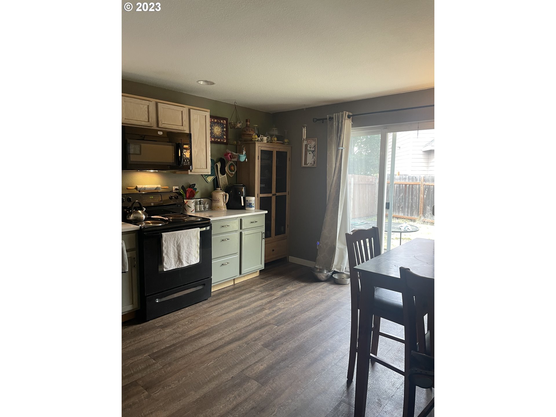 4124 Forsythia Street Springfield, OR 97478 - Photo 7 of 12 a kitchen with stainless steel appliances a microwave a stove a sink and cabinets