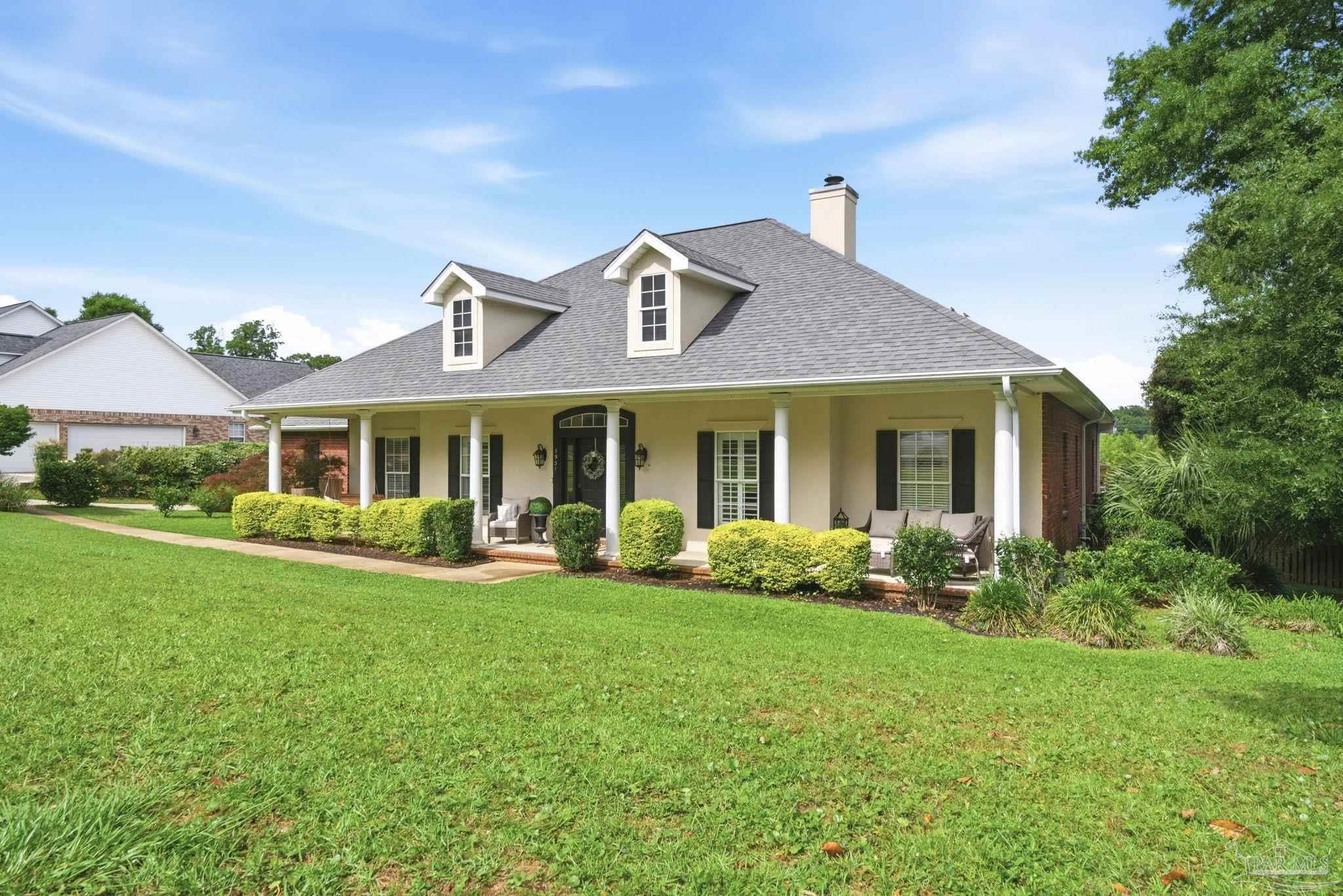 5931 Otter Point Road Pensacola, FL 32504 - Photo 2 of 67 a front view of a house with garden and porch