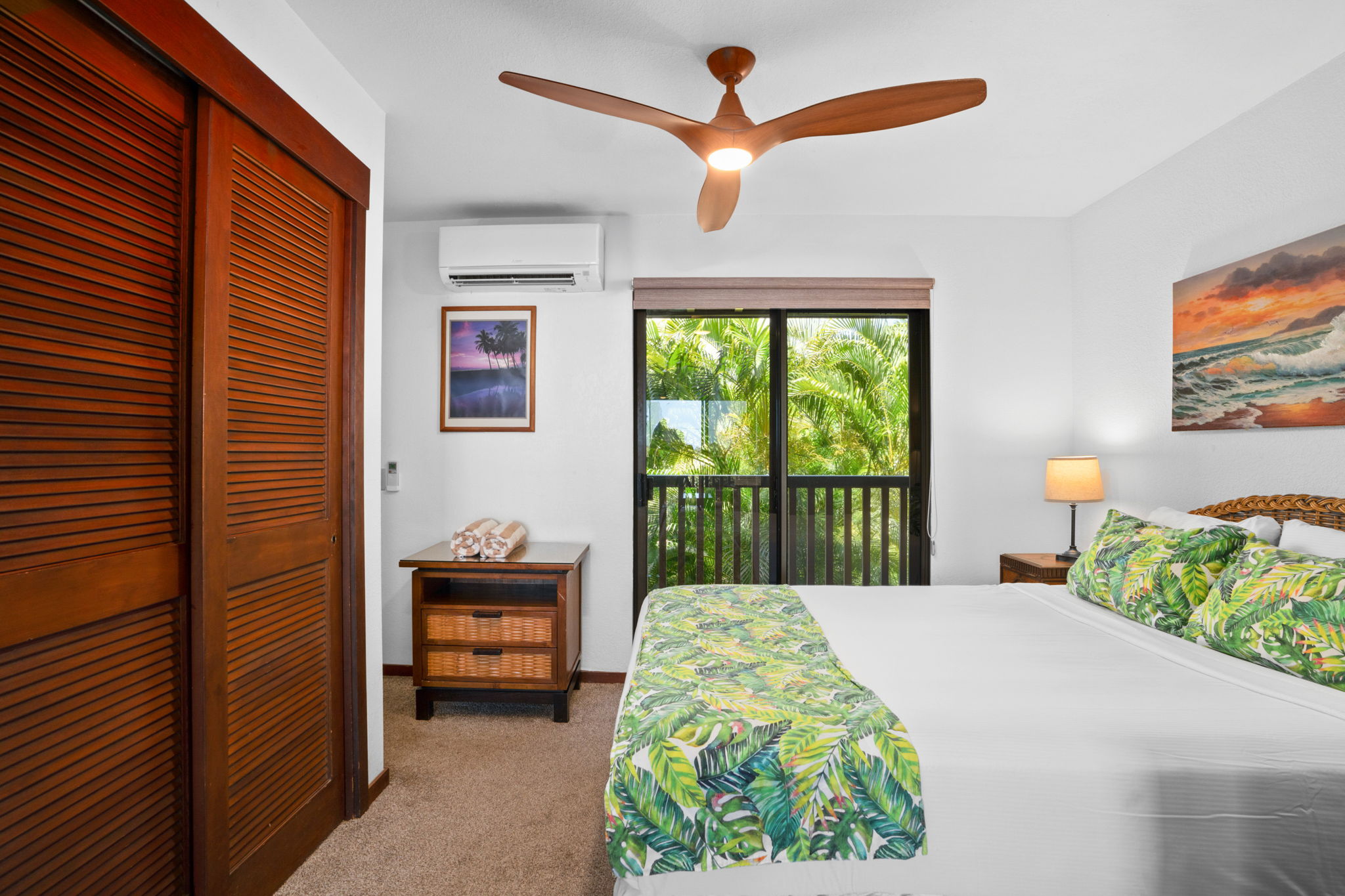 1870 Hoone Road, Unit 511 Koloa, HI 96756 - Photo 13 of 30 a bedroom with a bed and a painting on the wall