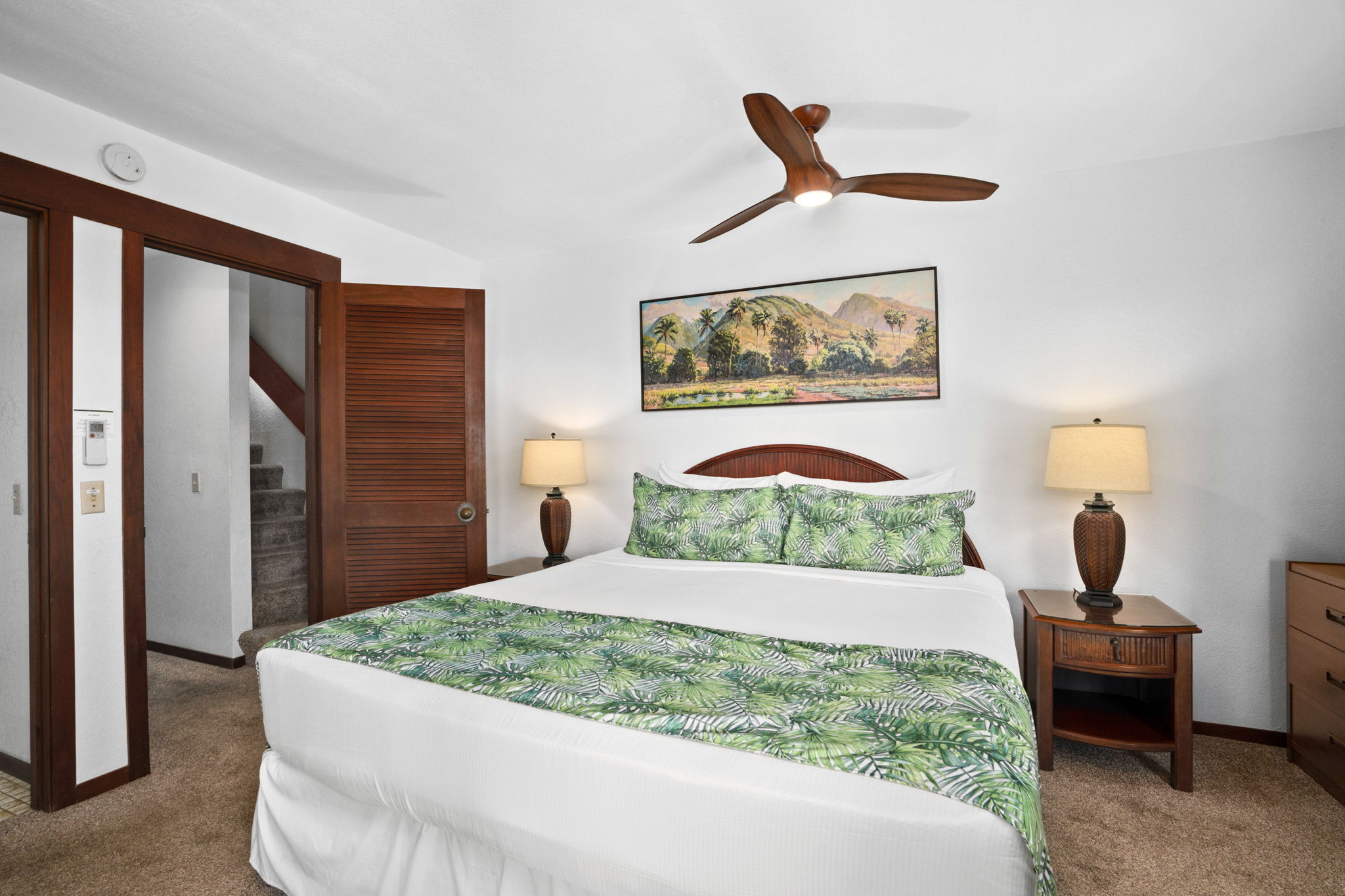 1870 Hoone Road, Unit 511 Koloa, HI 96756 - Photo 17 of 30 a bedroom with a bed and a painting on the wall