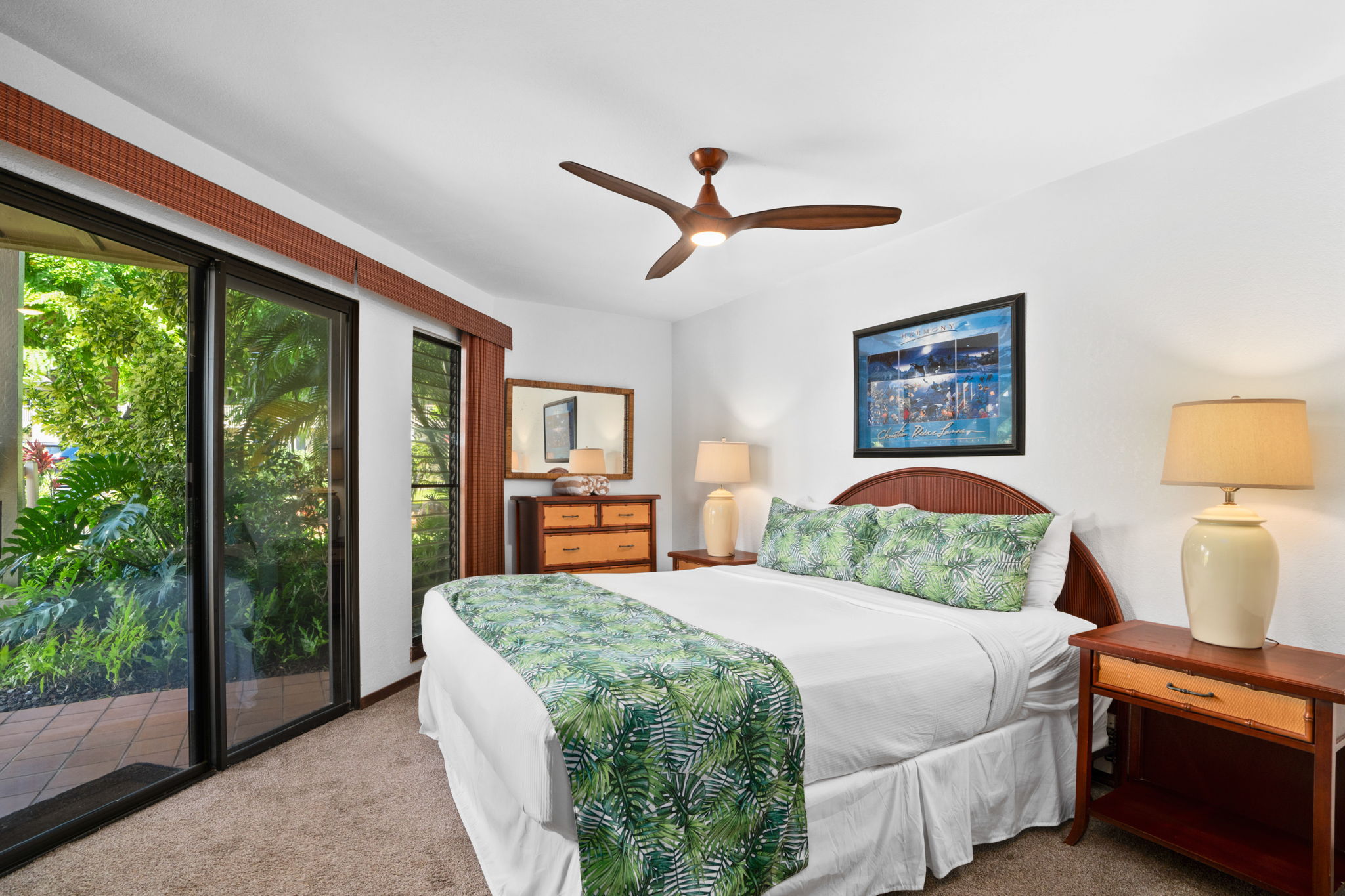 1870 Hoone Road, Unit 511 Koloa, HI 96756 - Photo 20 of 30 a bedroom with a balcony a bed and a painting on the wall