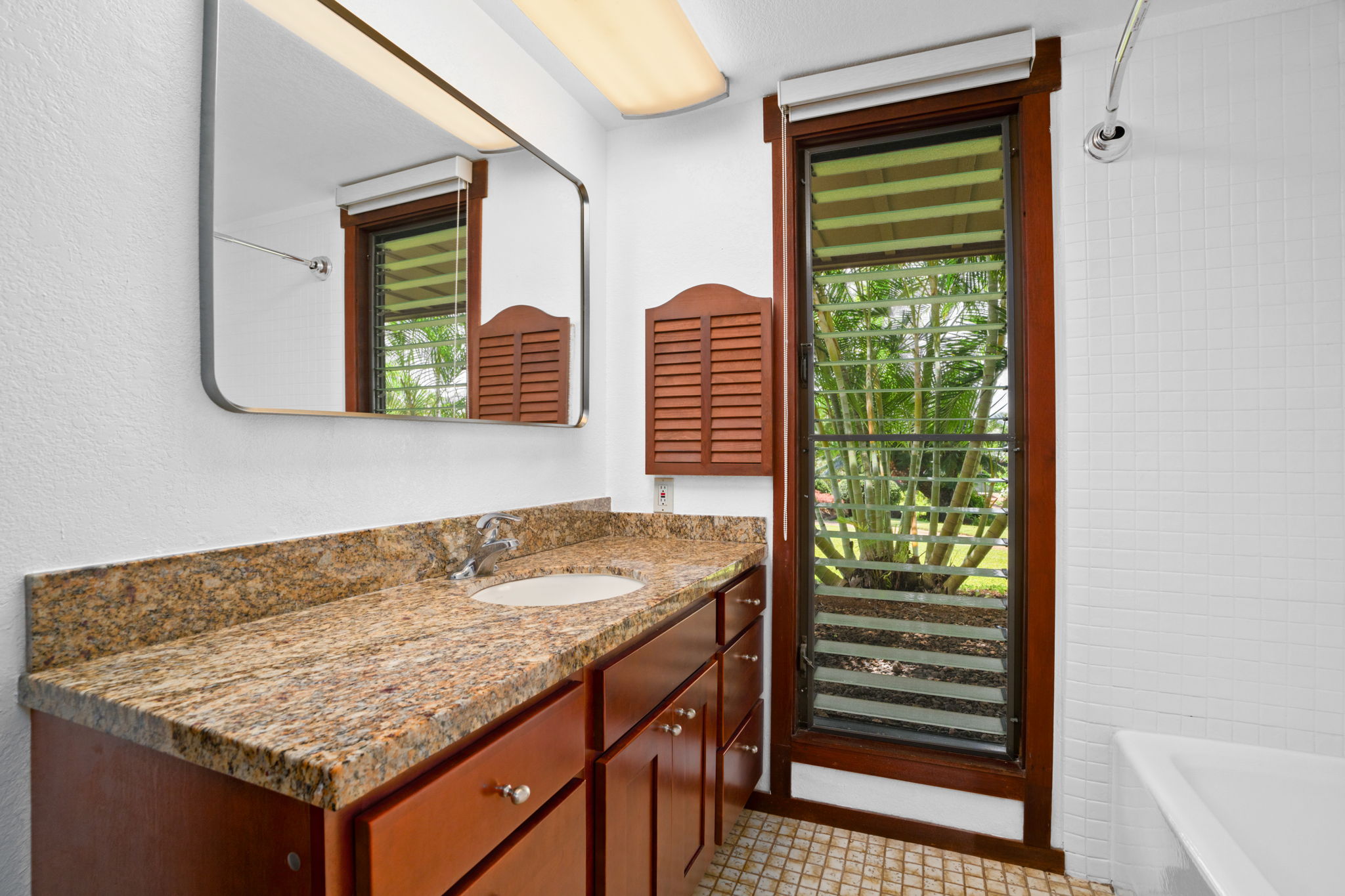 1870 Hoone Road, Unit 511 Koloa, HI 96756 - Photo 21 of 30 a bathroom with a granite countertop sink and vanity
