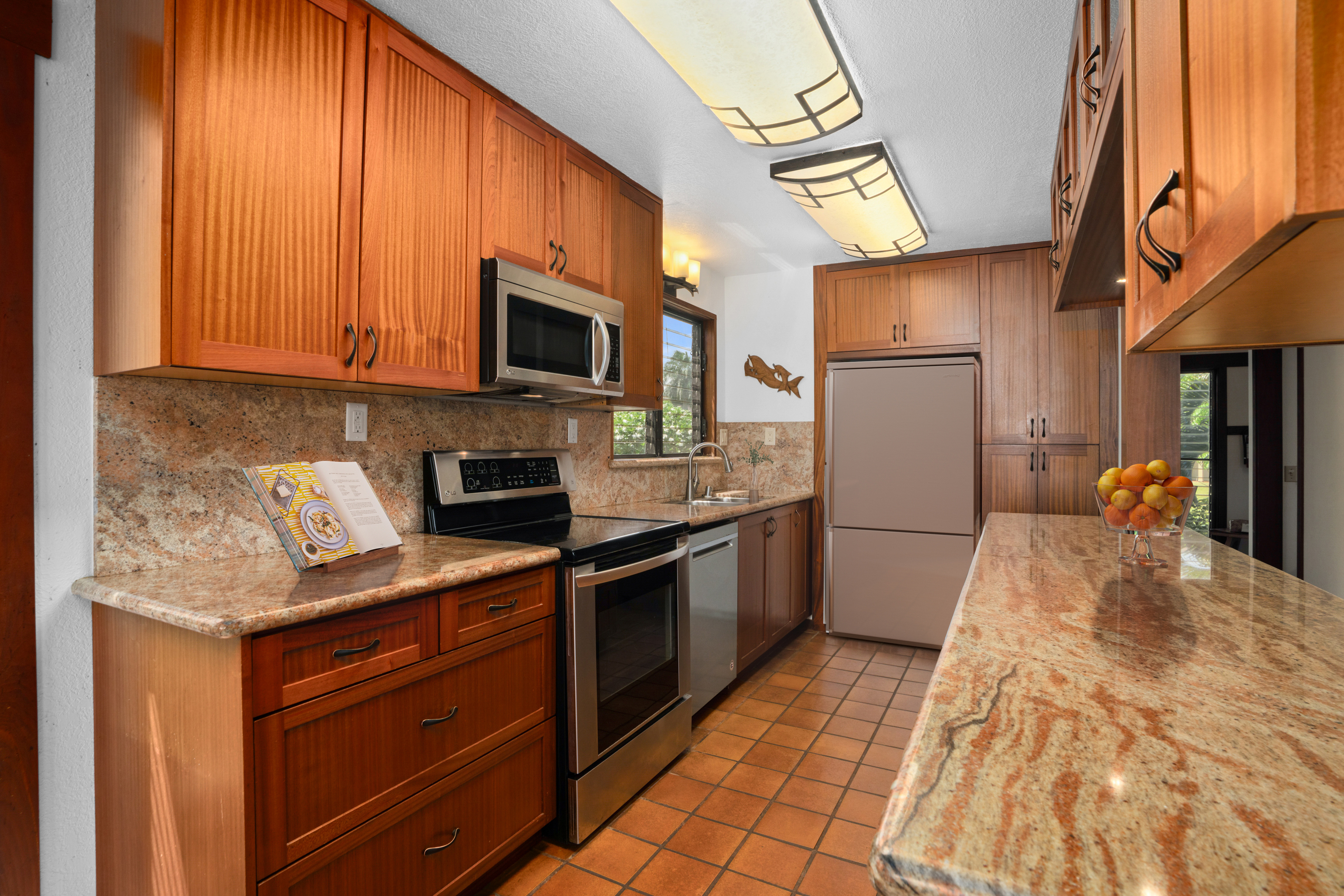 1870 Hoone Road, Unit 511 Koloa, HI 96756 - Photo 9 of 30 a kitchen with stainless steel appliances granite countertop a refrigerator a stove top oven a sink and dishwasher