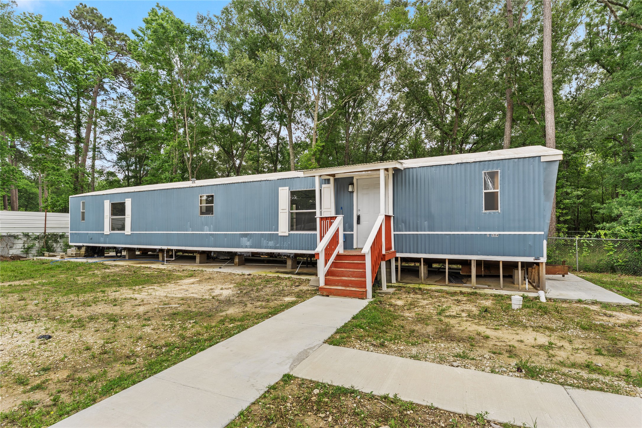 21504 Mexican John Road New Caney, TX 77357 - Photo 14 of 15 Paved walkway from parking to front door.
