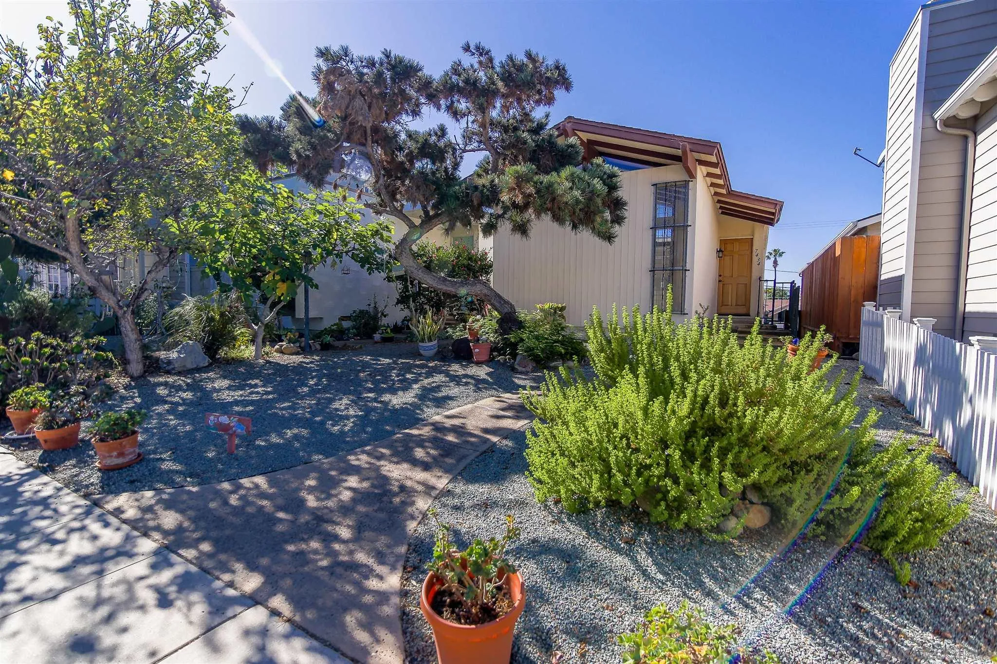7434 High Avenue La Jolla, CA 92037 - Photo 2 of 15 a front view of a house with a yard