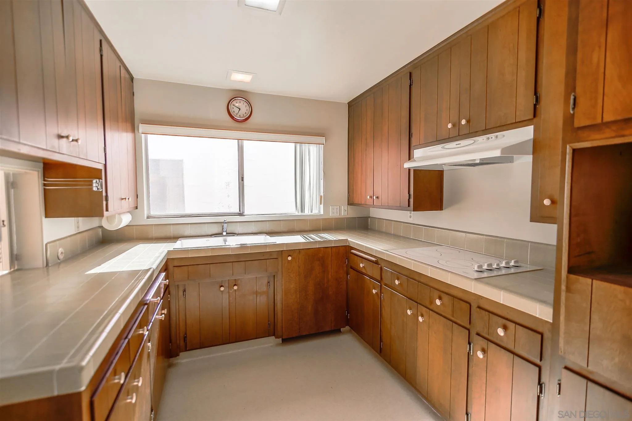 7434 High Avenue La Jolla, CA 92037 - Photo 6 of 15 a kitchen with a sink window and cabinets