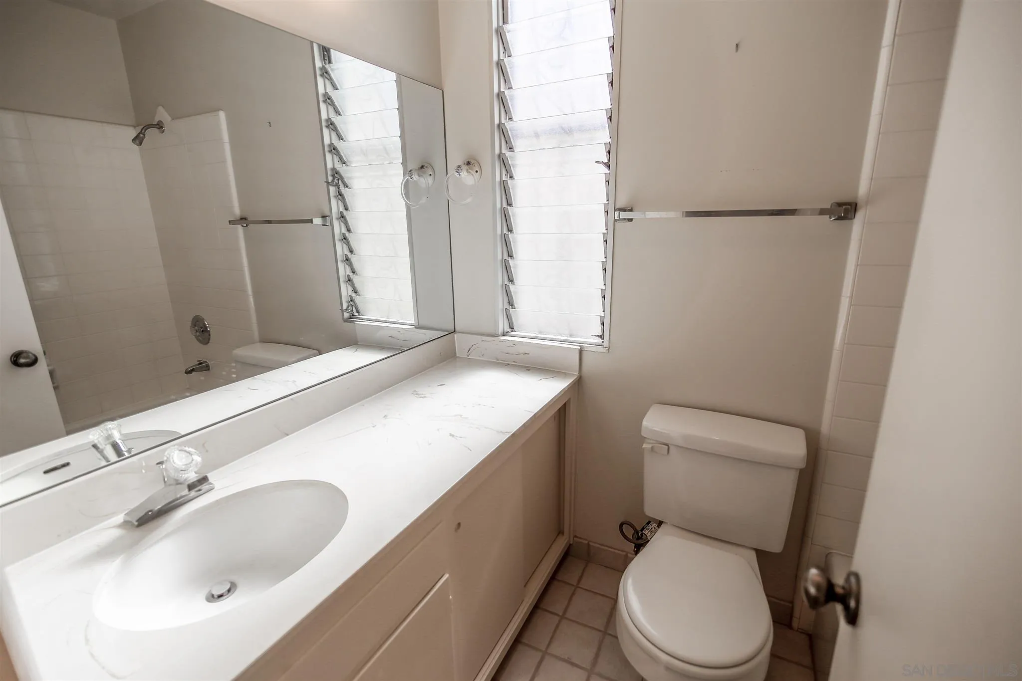 7434 High Avenue La Jolla, CA 92037 - Photo 9 of 15 a bathroom with a sink toilet and shower