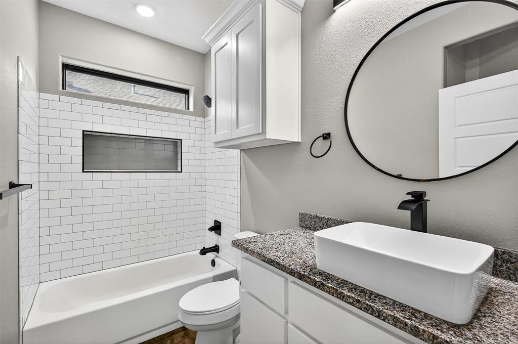 1501 South 7th Avenue Denison, TX 75021 - Photo 17 of 32 a bathroom with a sink toilet and shower
