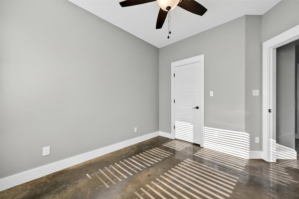 1501 South 7th Avenue Denison, TX 75021 - Photo 19 of 32 an empty room with wooden floor fan and windows