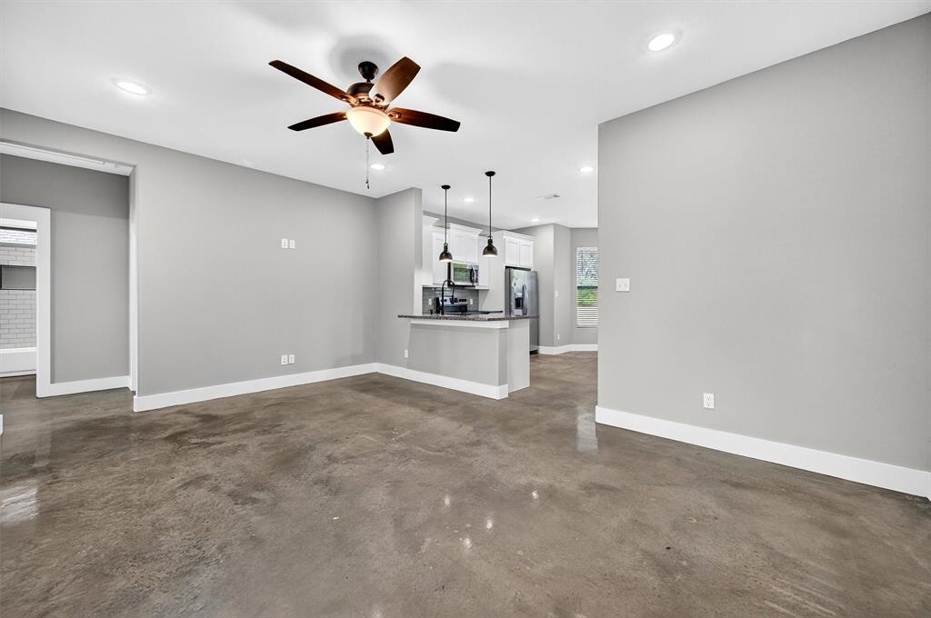 1501 South 7th Avenue Denison, TX 75021 - Photo 7 of 32 an empty room with cabinet and ceiling fan