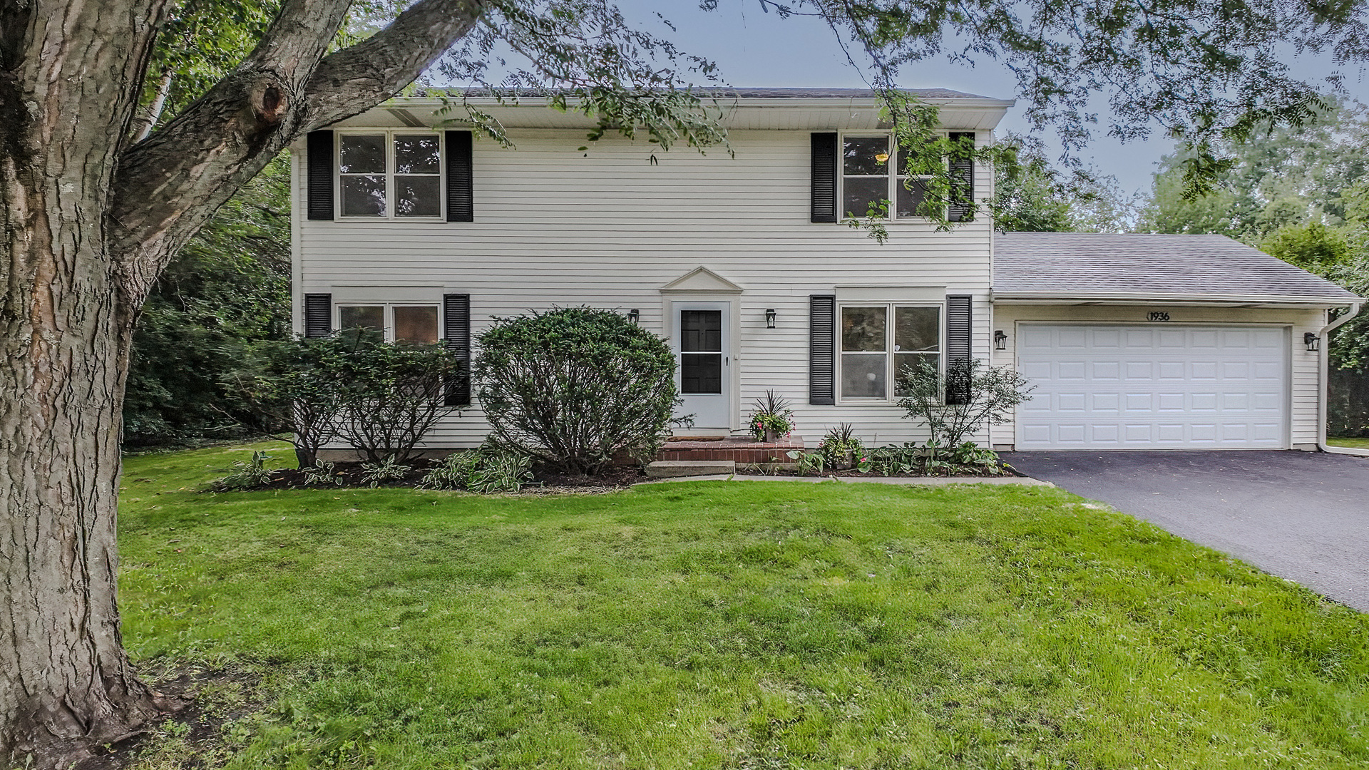 1936 South Street Geneva, IL 60134 - Photo 1 of 34 a front view of a house with a garden