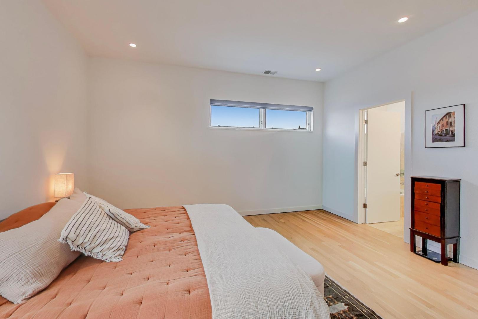 4410 North Troy Street, Unit 301 Chicago, IL 60625 - Photo 11 of 23 a bedroom with a bed and a lamp on table