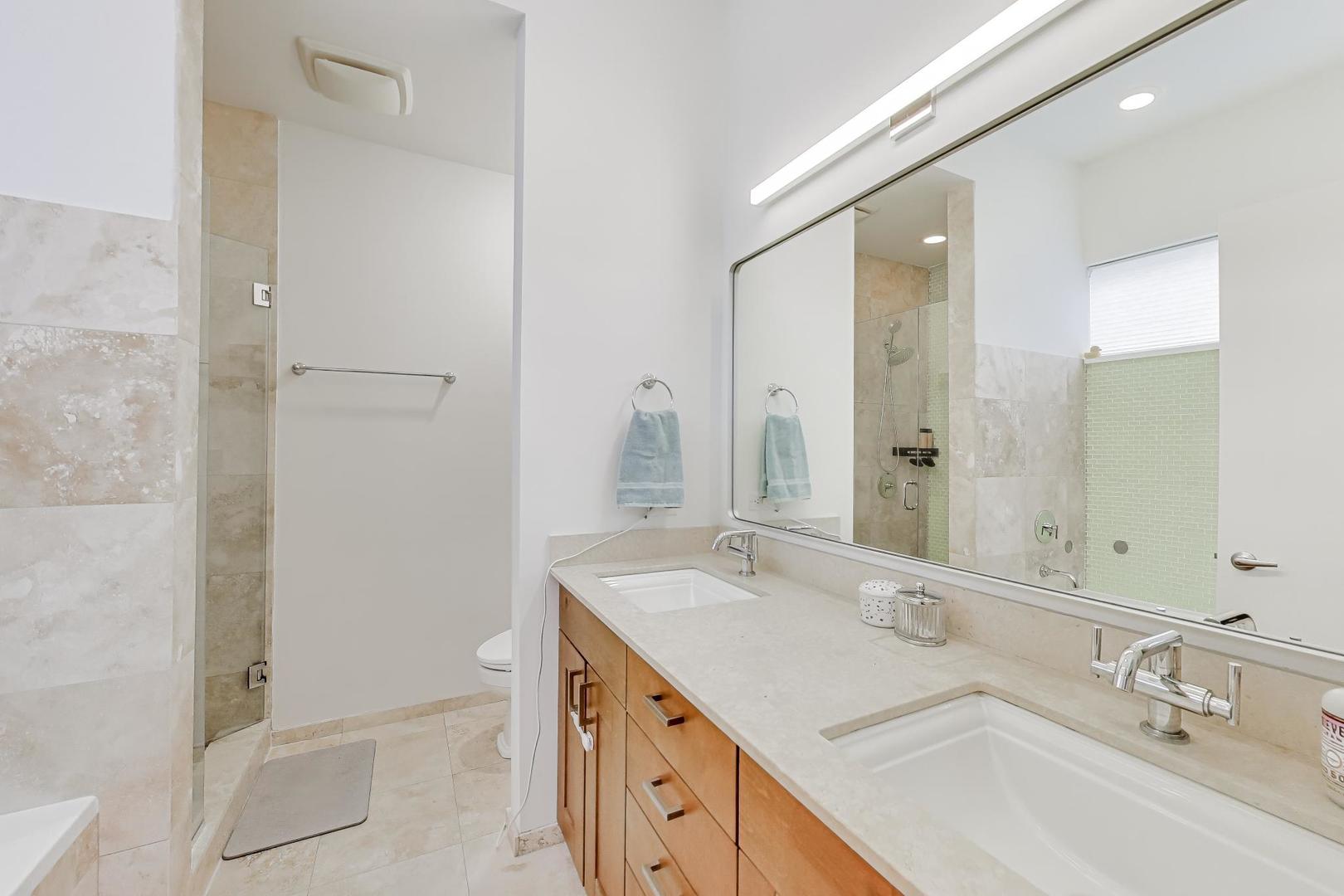 4410 North Troy Street, Unit 301 Chicago, IL 60625 - Photo 13 of 23 a bathroom with a sink and a mirror with bathtub
