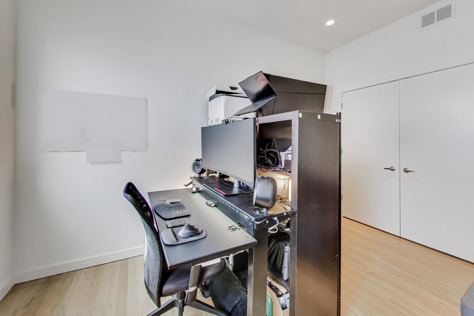 4410 North Troy Street, Unit 301 Chicago, IL 60625 - Photo 19 of 23 a view of a workspace with furniture and wooden floor
