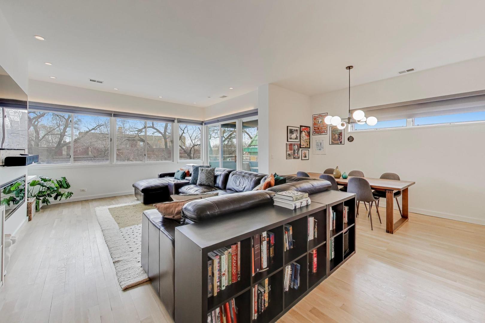 4410 North Troy Street, Unit 301 Chicago, IL 60625 - Photo 2 of 23 a living room with furniture a window and a chandelier