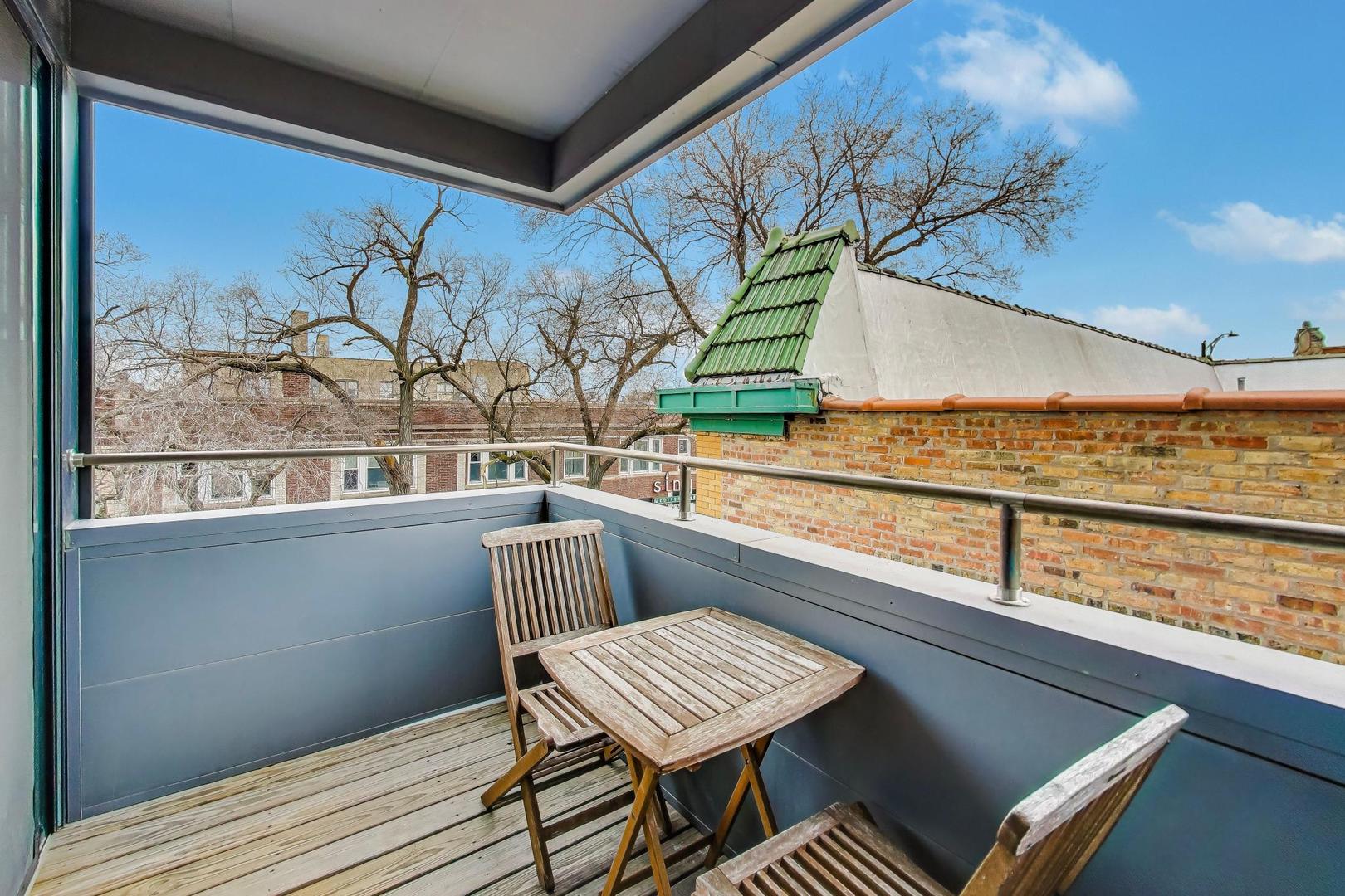 4410 North Troy Street, Unit 301 Chicago, IL 60625 - Photo 21 of 23 a view of a chairs and table in a balcony