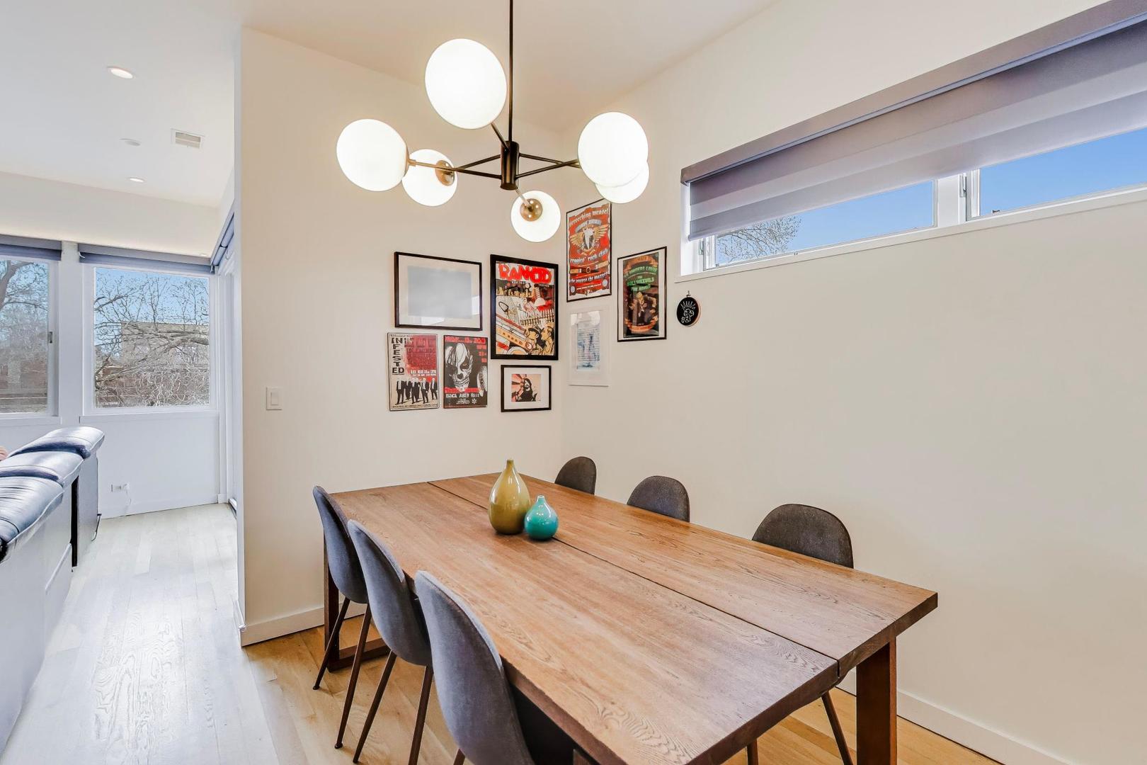 4410 North Troy Street, Unit 301 Chicago, IL 60625 - Photo 6 of 23 a view of a dining room with furniture and wooden floor