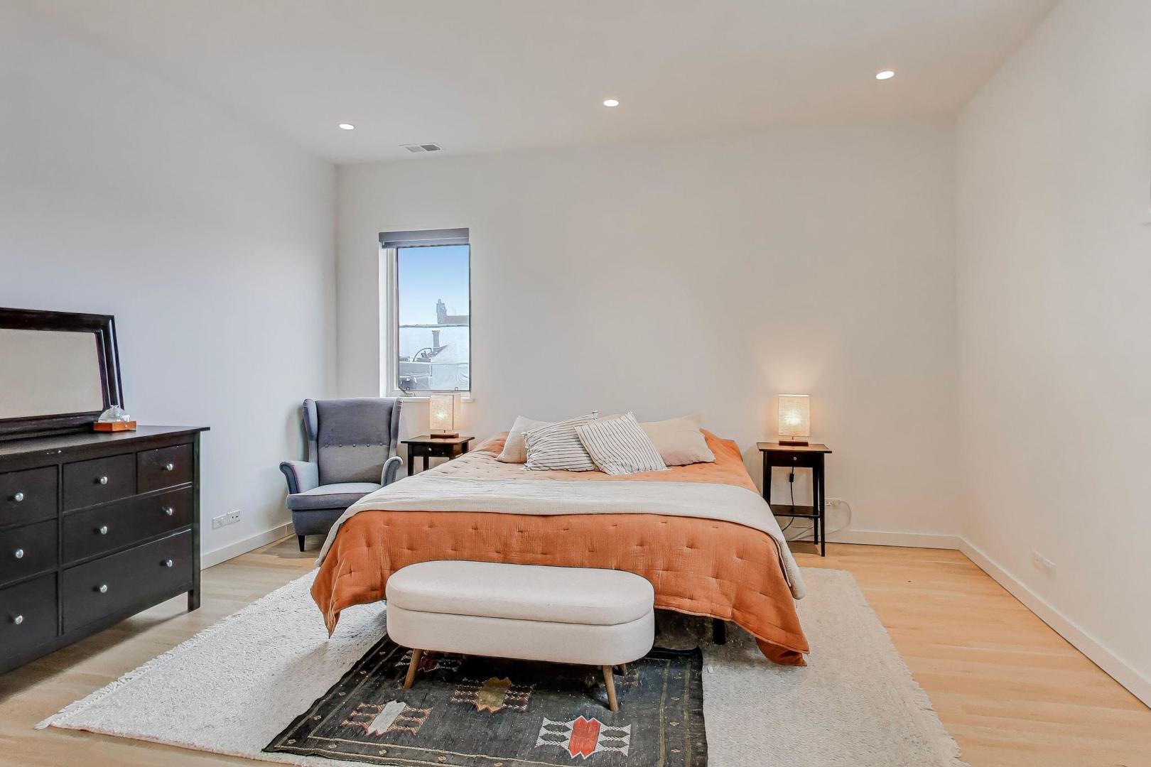 4410 North Troy Street, Unit 301 Chicago, IL 60625 - Photo 10 of 23 a bedroom with a bed and a dresser in it
