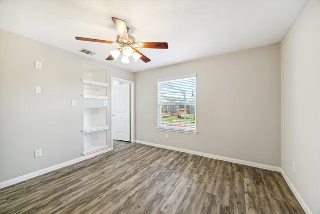 wooden floor in an empty room with a window