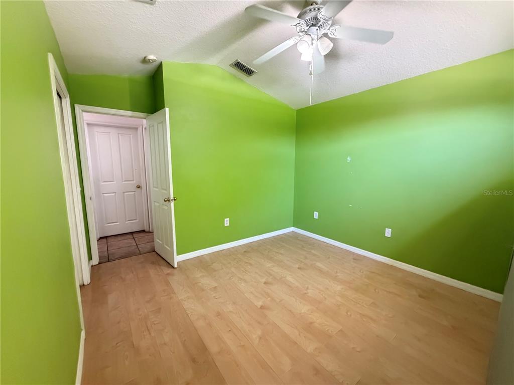 945 Tramells Trail Kissimmee, FL 34744 - Photo 19 of 36 a view of a room with a chandelier fan and closet
