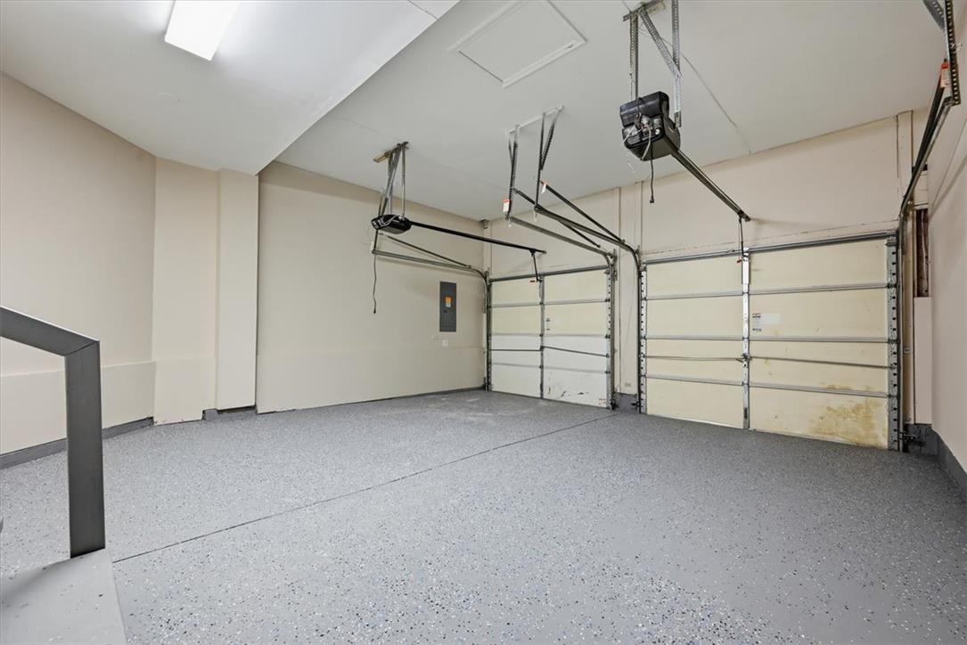 8761 Cascade Road Breinigsville, PA 18031 - Photo 74 of 84 A spacious, clean garage featuring two bay doors and a durable speckled floor.