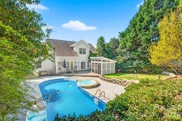 a view of a house with swimming pool and sitting area