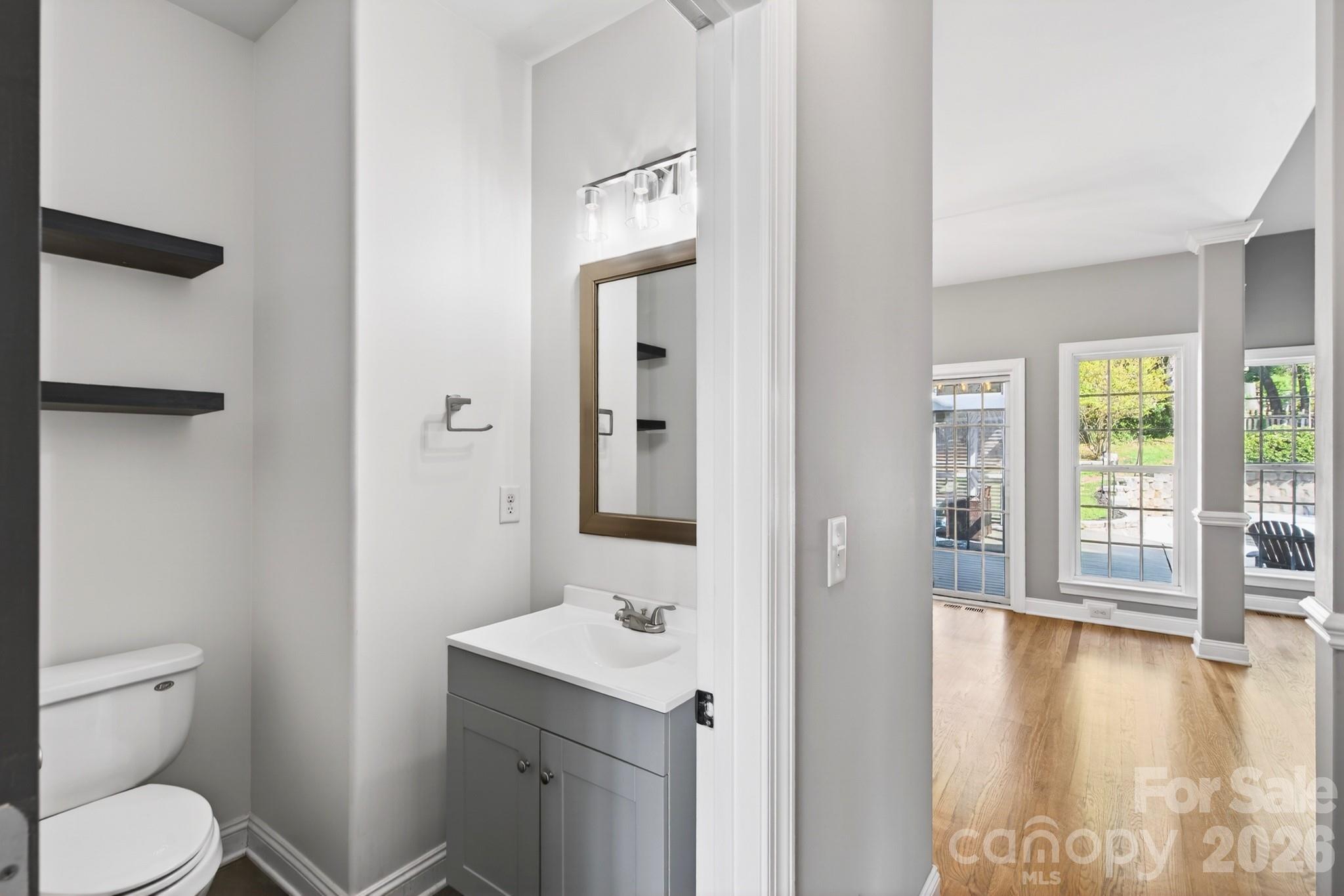 9101 Pitcairn Drive Tega Cay, SC 29708 - Photo 11 of 48 a bathroom with a toilet a sink and mirror