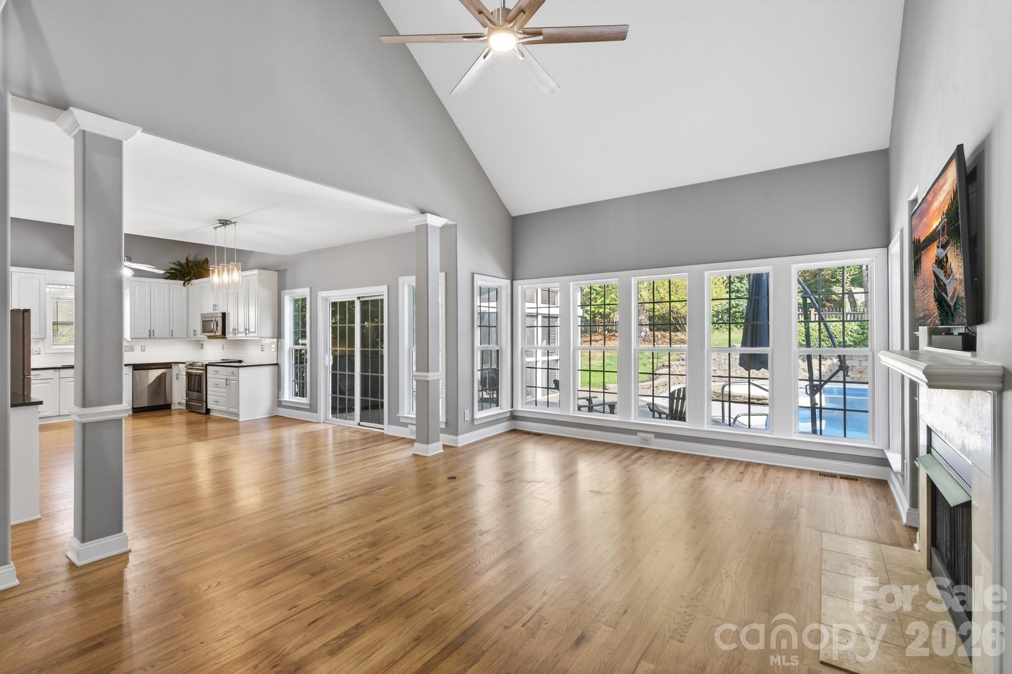9101 Pitcairn Drive Tega Cay, SC 29708 - Photo 14 of 48 a view of empty room with wooden floor and fireplace